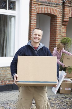 House movers loading furniture on a residential street in Brent