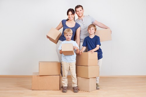 Local movers handling furniture in Brent residential street
