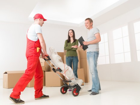 Mover wearing PPE while handling boxes and furniture