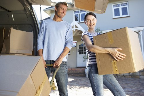 Removal team handling furniture in a residential Brent property